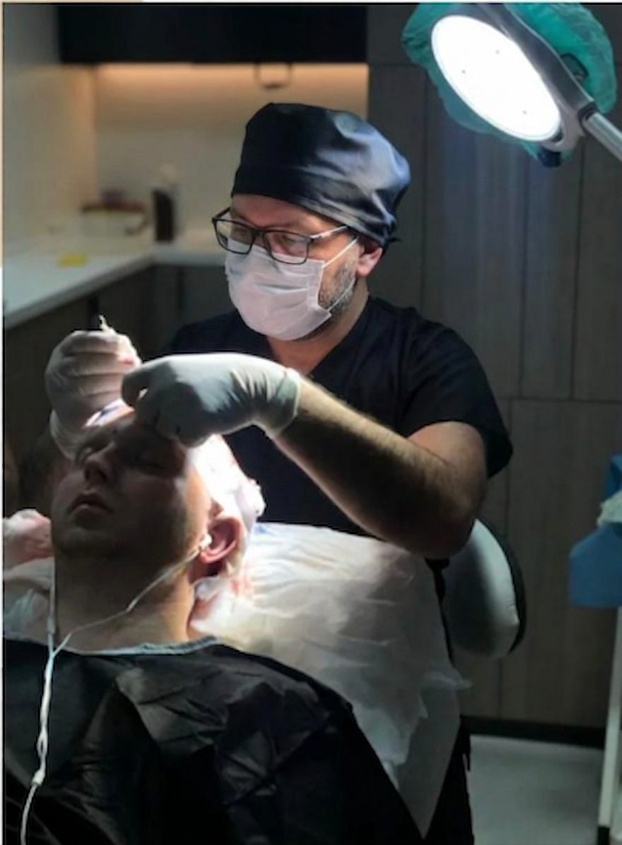 Physician preparing grafts under a microscope